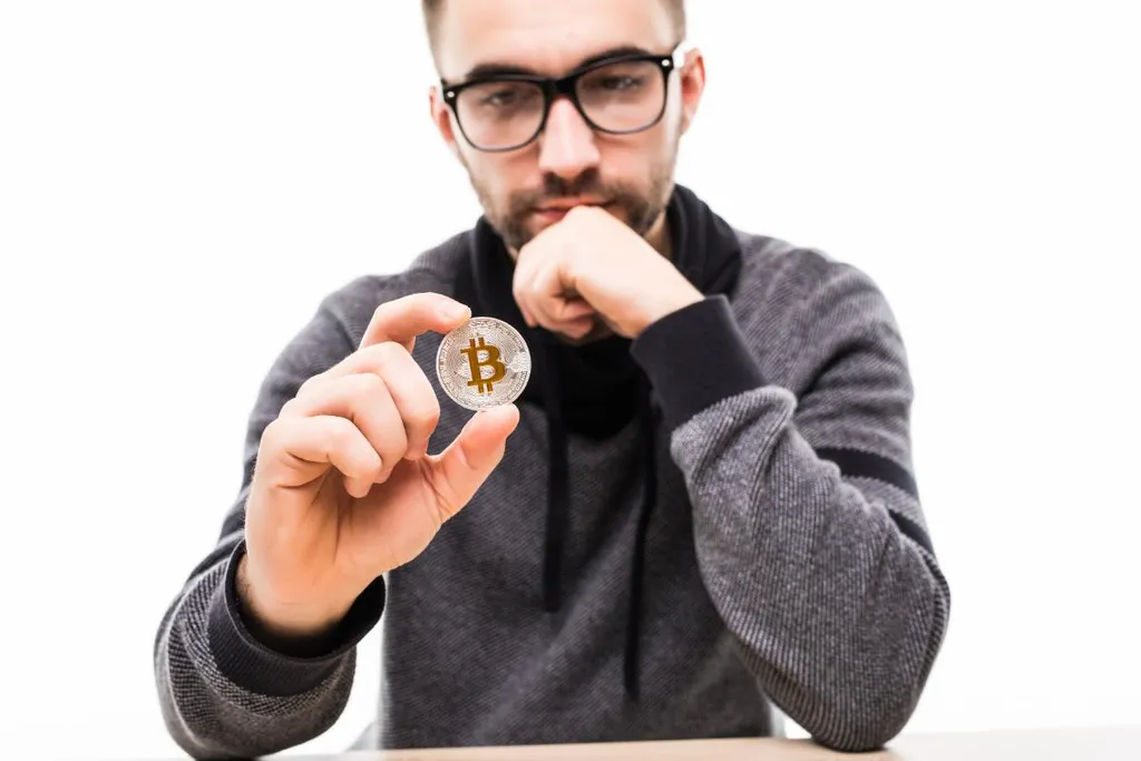 handsome-young-man-thinking-bitcoin-isolated-white.jpg
